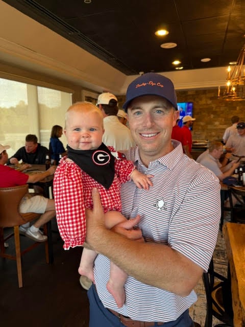 Player with baby fan at the clubhouse