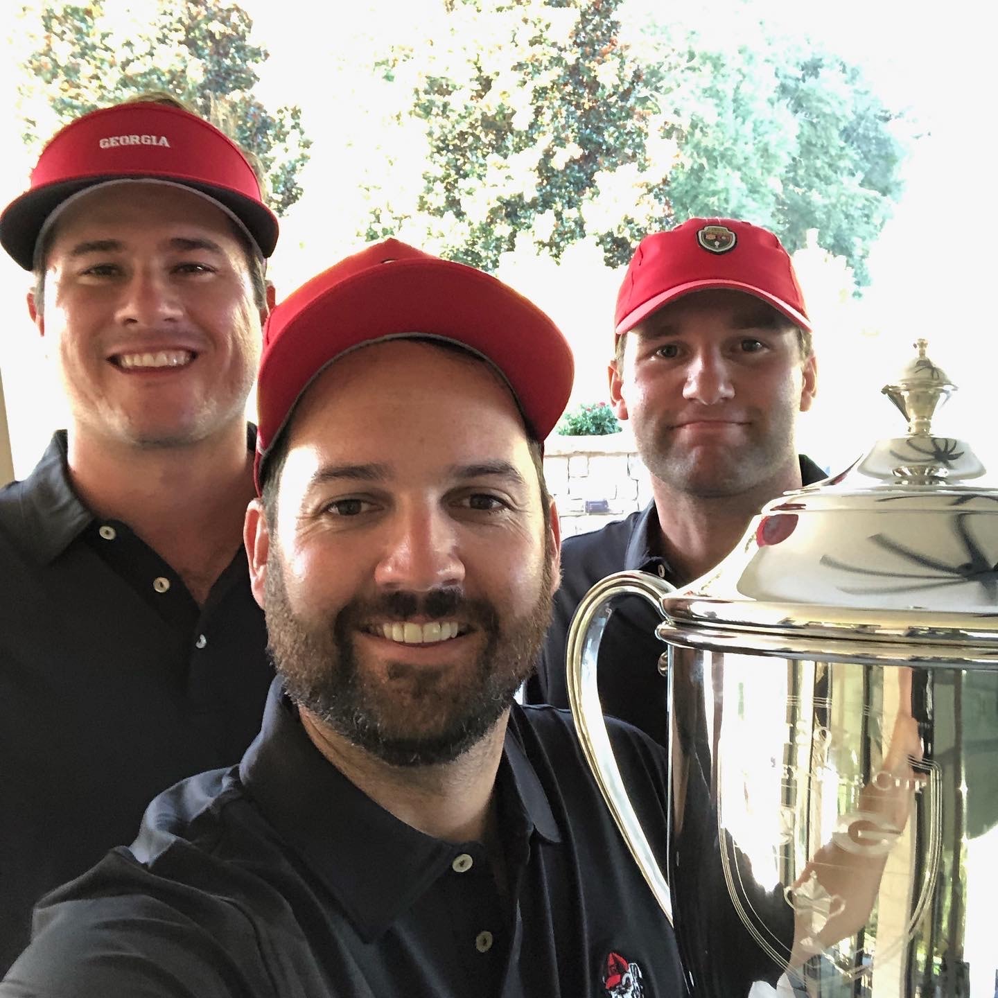 Three players with the Dooley-Dye Cup