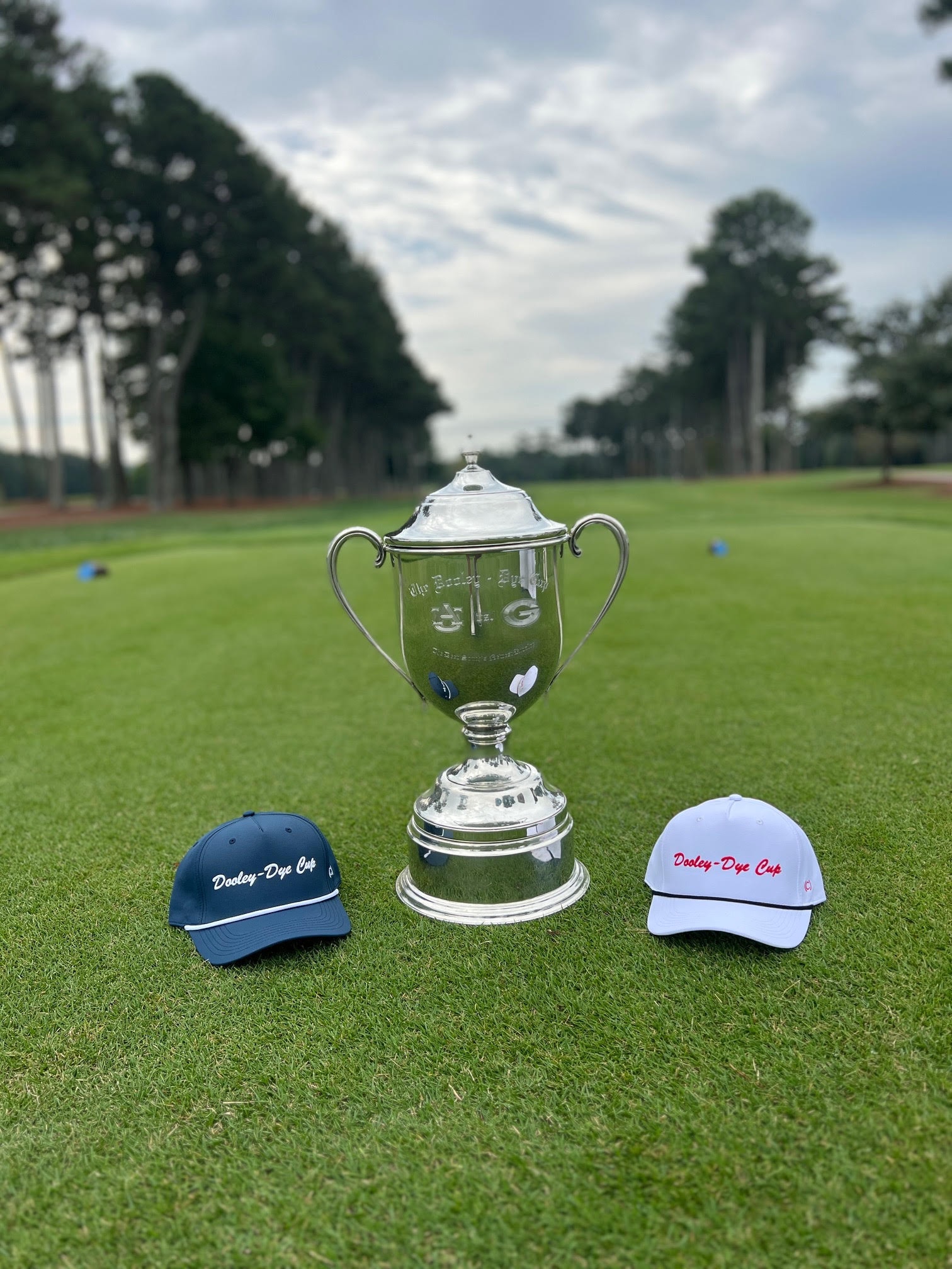Trophy with Dooley-Dye Cup caps on the green