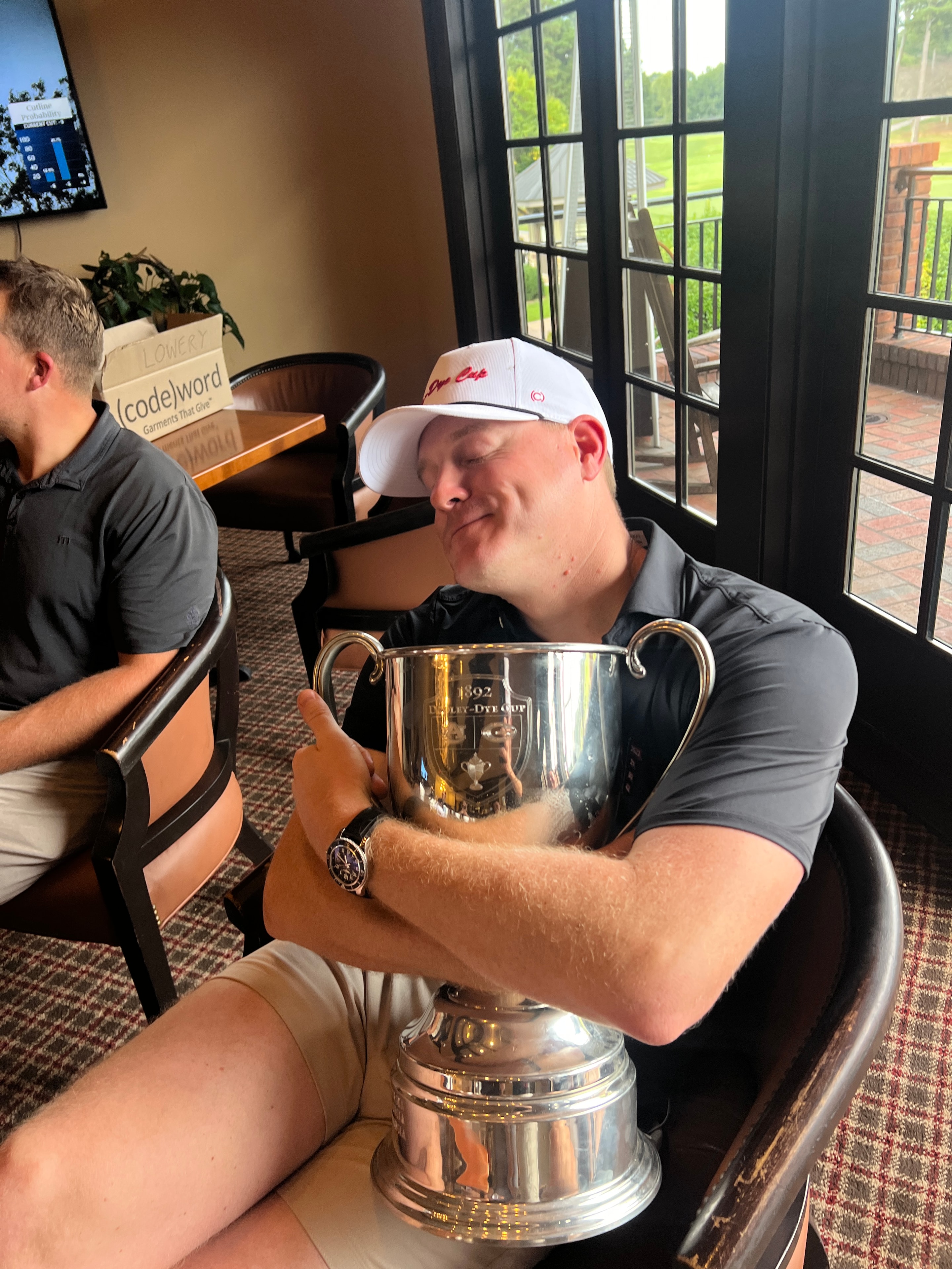 Player drinking from the Dooley-Dye Cup trophy