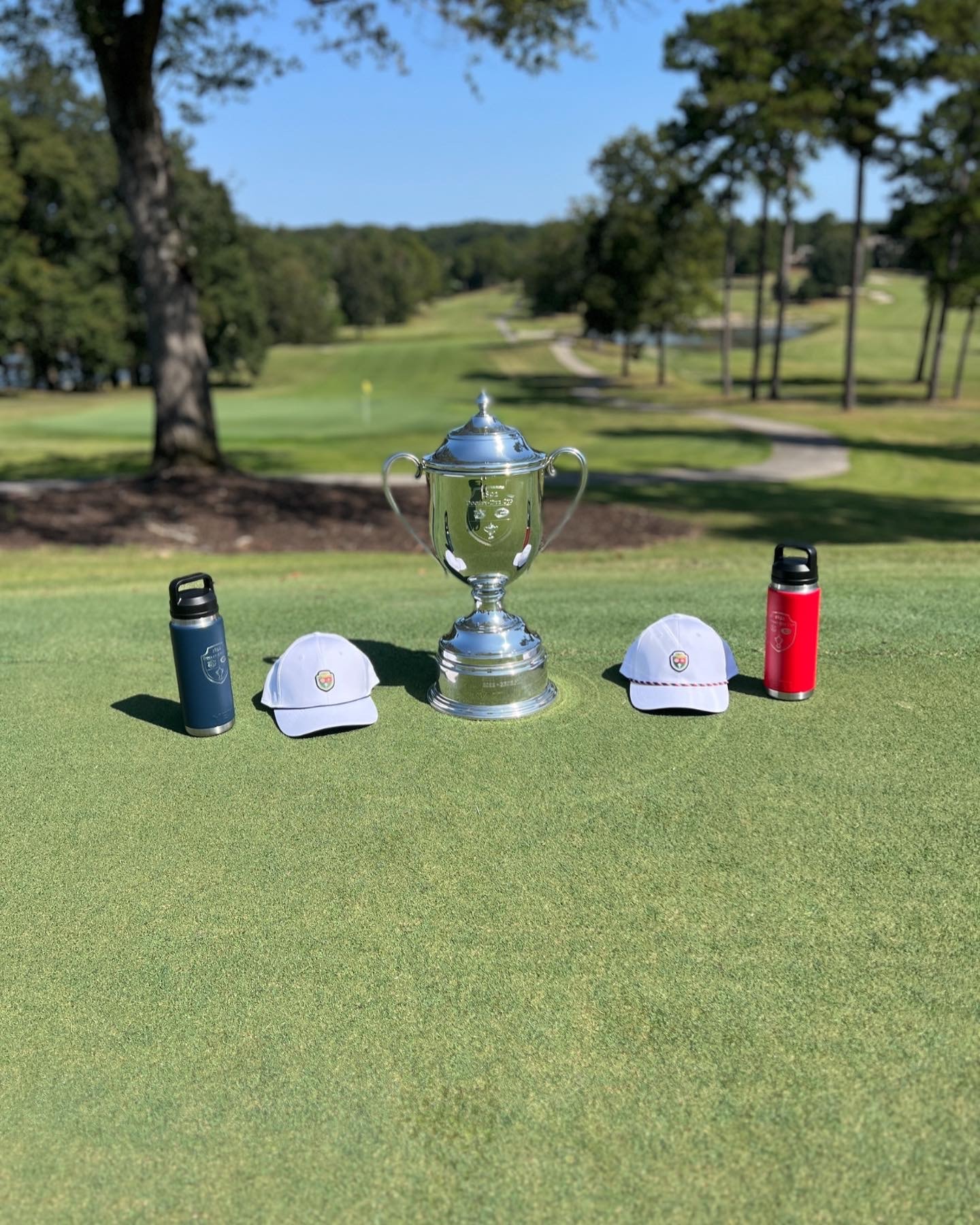 Trophy with caps and thermoses on the green
