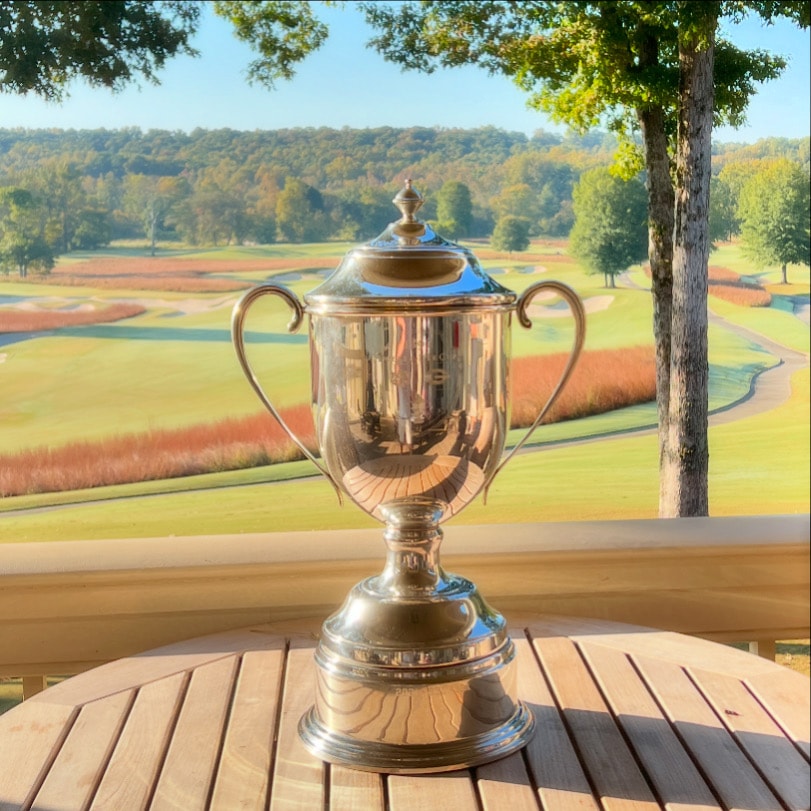The Dooley-Dye Cup trophy on a deck overlooking the course