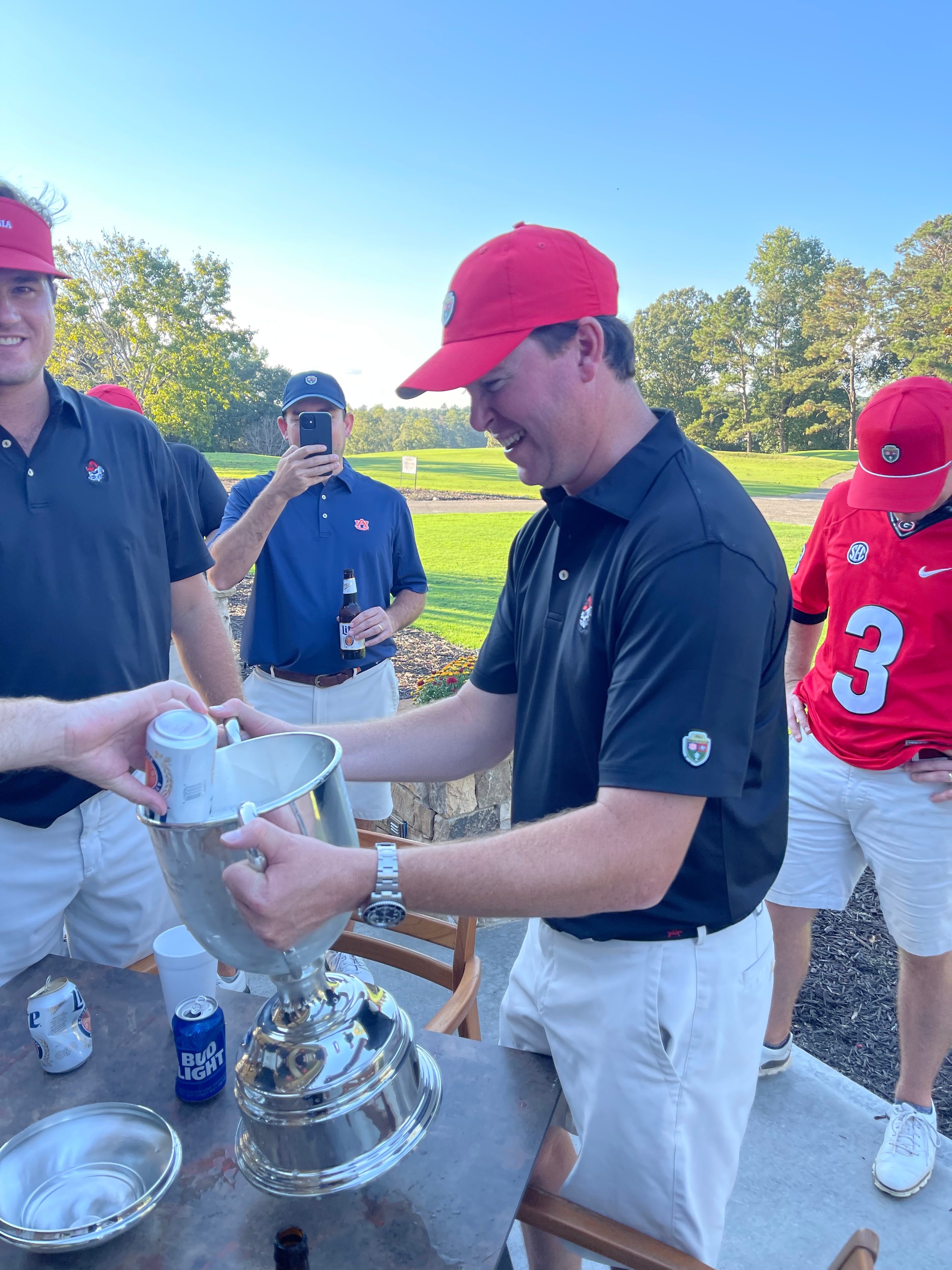 Player pouring a drink from the Dooley-Dye Cup on the patio